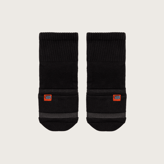 Pair of black Crease Beast Pocket Socks - Ankle, with orange Crease Beast label and gray stripes, front view.