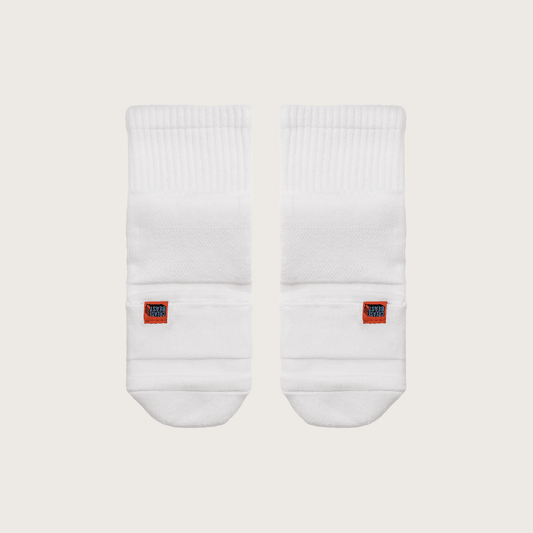 Front view of two white Crease Beast Pocket Socks with an orange Crease Beast label on each sock.