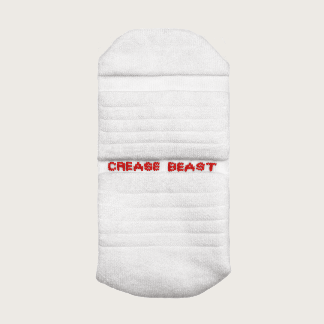 Front view of a white Crease Beast ankle sock with "CREASE BEAST" embroidered in red on the front.