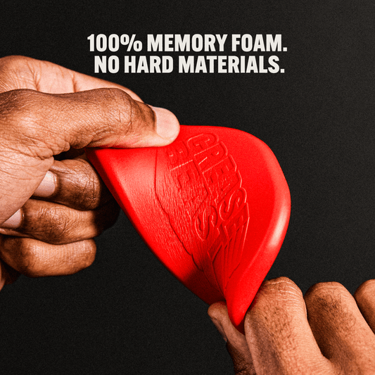 Close-up of hands squeezing a red CREASE BEAST memory foam crease protector, showing its flexibility.