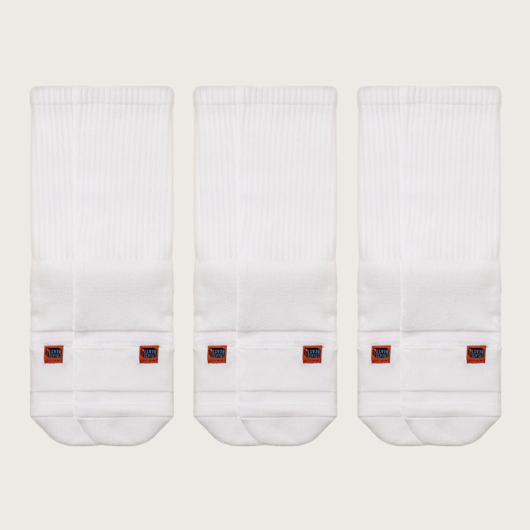 Three pairs of white Crease Beast Pocket Socks - Crew, each with an orange Crease Beast label.