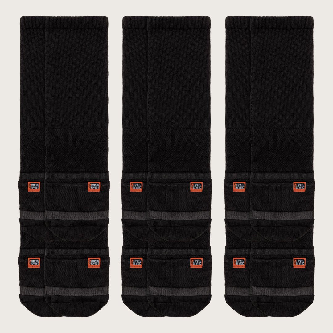 Three pairs of black Crease Beast Pocket Socks - Crew, each with an orange Crease Beast label and gray stripes.