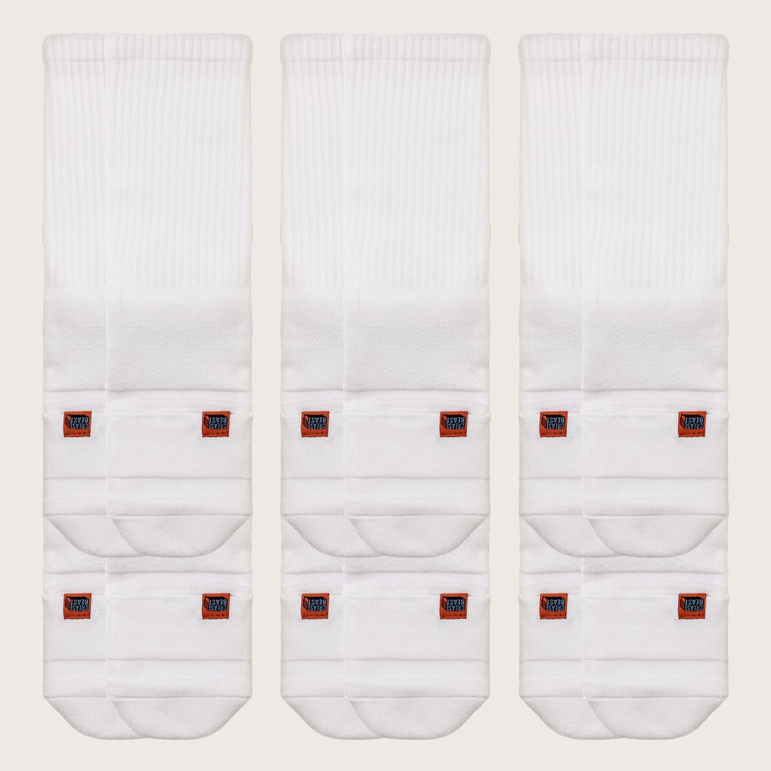 Three pairs of white Crease Beast Crew Pocket Socks, each with two orange Crease Beast brand tags.