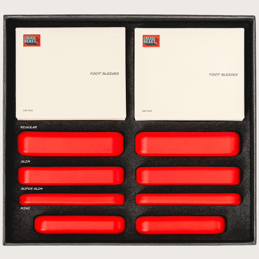 Crease Beast Ultimate Kit, top-down view. Two white boxes of "Foot Sleeves" and eight red crease protectors in four sizes.