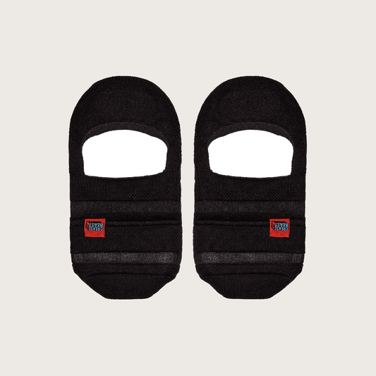 Front view of two black Crease Beast no-show pocket socks, each with a red brand label.