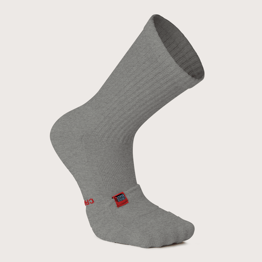 Single gray Crease Beast crew sock with a red brand tag on the side, angled on a white background.