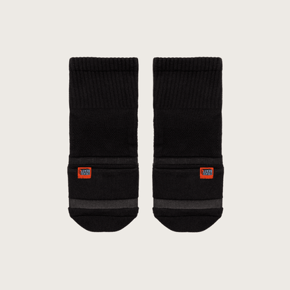 Pair of black Crease Beast Pocket Socks - Ankle, with orange Crease Beast label and gray stripes, front view.