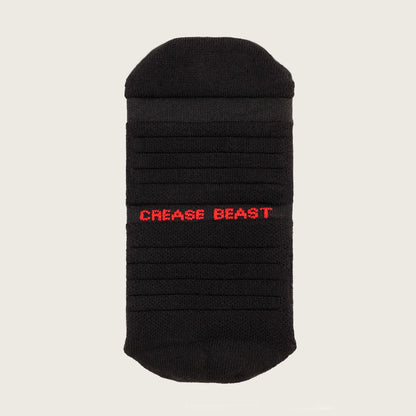 Front view of a black Crease Beast ankle sock with "CREASE BEAST" in red text on the side.