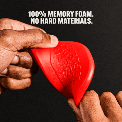 Close-up of hands squeezing a red CREASE BEAST memory foam crease protector, showing its flexibility.