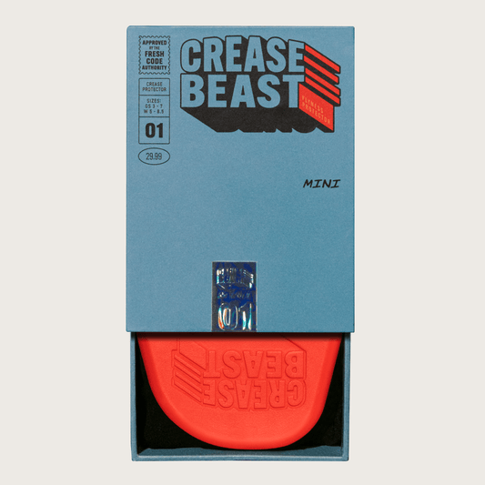 Front view of a blue Crease Beast Mini box with an orange Crease Beast Flyness Protector inside.