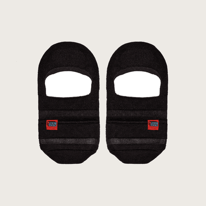 Front view of two black Crease Beast no-show pocket socks, each with a red brand label.